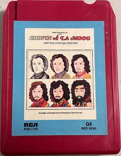 A photo of a vintage red plastic 8-track cartridge tape entitled "Sonart Productions Inc. presents Chopin à la Moog . . . with lots of strings attached." Inset artwork includes a series of 6 illustrated headshots, morphing gradually from the 1st (a b&w drawing of Chopin in period garb) to the last (a hirsute hippie sporting a headband and lovebeads). Text beneath the artwork reads "arranged, conducted, and synthesized by Hans Wurman."