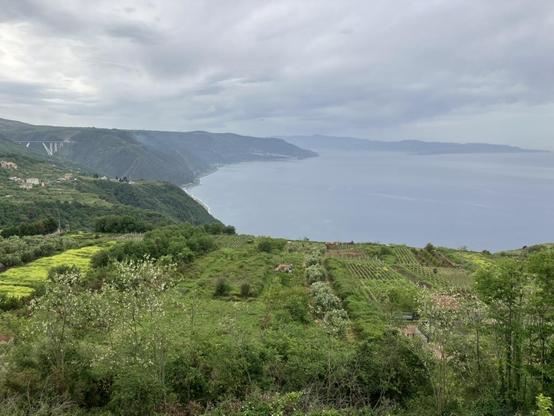 View over the Gulf of Joy towards the Straight of Messina from the hills on the descent towards the sea.