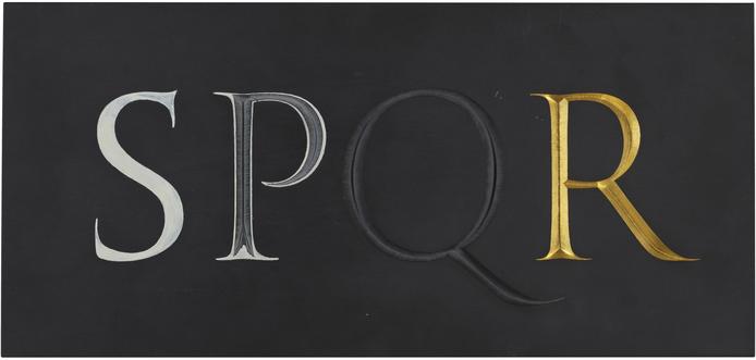 A black slate with SPQR carved into the center. The letter S painted in white, the P is cut with the white painted edges visible, the Q has no paint visible, and the R is gilt in gold leaf.