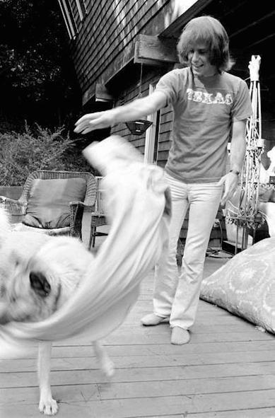 Bob Weir (human) plays with Otis (dog) on their back porch