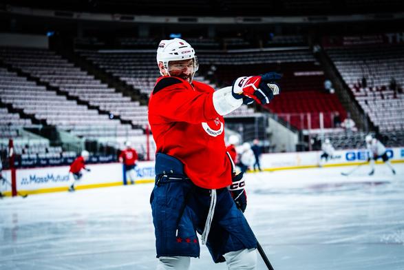 Alex Ovechkin smiles and points.