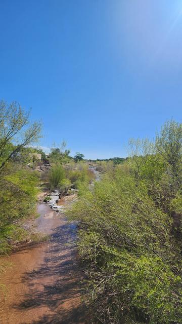 color photo of a high desert river facing in a southwesterly direction
