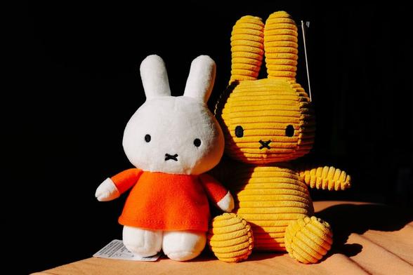 A Miffy in orange and an orange Miffy.