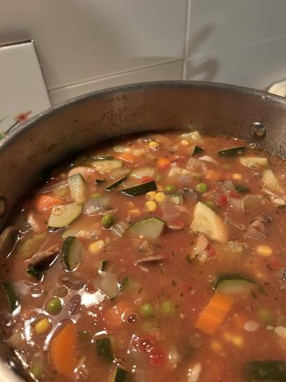 A large saucepan of minestrone soup, filled with zucchini, carrots, peas, corn, mushrooms, onions, celery & tomato, plus anything else that took my fancy as I was cooking it. Home make chicken broth as the base.