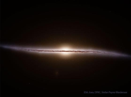 What does our Milky Way Galaxy look like from the side? Because we are on the inside, humanity can’t get an actual picture. Recently, however, just such a map has been made using location data for over a billion stars from ESA’s Gaia mission. The resulting featured illustration shows that just like many other spiral galaxies, our Milky Way has a very thin central disk. Our Sun and all the stars we see at night are in this disk. Although hypothesized before, perhaps more surprising is that the disk appears curved at the outer edges. The colors of our Galaxy's warped central band derive mostly from dark dust, bright blue stars, and red emission nebulas. Although data analysis is ongoing, Gaia was deactivated in March after a successful mission.