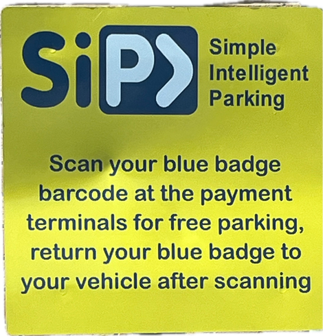 Parking sign. Claims to be simple intelligent parking. Instructions telling disabled people to enter the building, scan their badge, return to their car with their badge, then re-enter the building for their appointment.