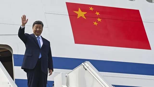 Xi on the stairs, with his Chinese jet behind him: