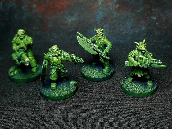 4 miniatures with a chaotic and spiky look, painted in vibrant green with blue shadows