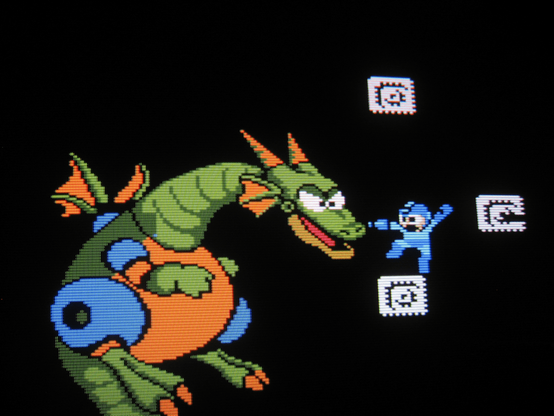 The Blue Bomber battles a fearsome robotic dragon, shoving his buster cannon right into the monster's snout!