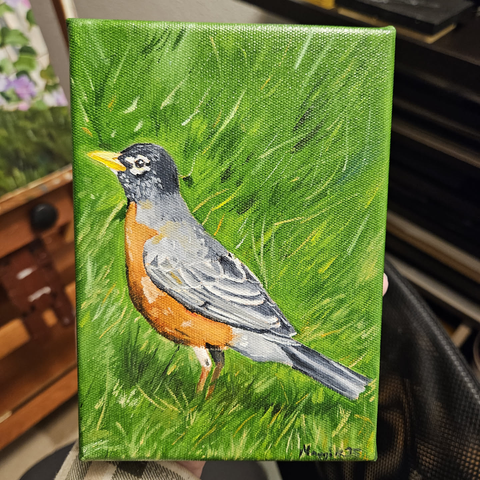 a 5x7 oil painting on canvas of an American Robin  - Turdus migratorius - standing in vibrant green grass looking to the left.