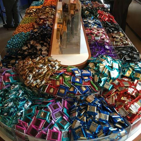 A large table displaying a vast amount of chocolate products.