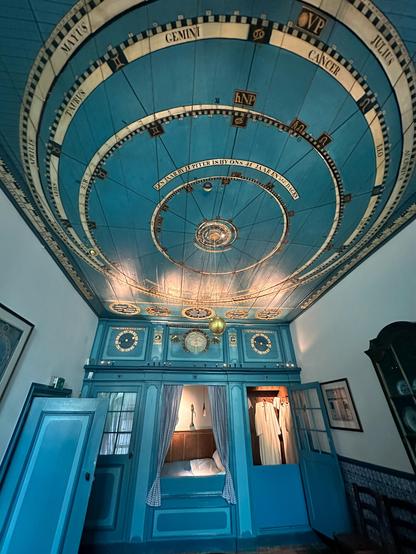 Picture of the living room with the working planetarium hanging from the ceiling. In the old days the sleeping bed in cupboard was normal to have in the living room.