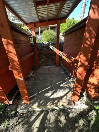 My wood store with the floor finished. It is made of red wood and the floor is a combination of flagstones, sandstone and pavers, all edged with pebbles.