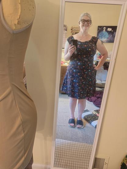 I am wearing a matching top and skirt in navy fabric with moons, stars and planets