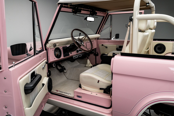 the   door is open, the  interior is white and pink with some black