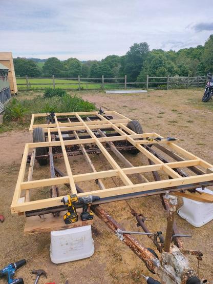 A wooden frame attached to a two wheel chassis