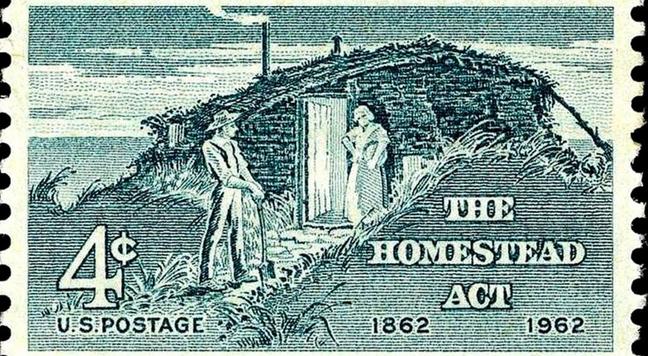 U.S. 4 cent postage stamp commemorating the Homestead Act, with image of white settlers standing beside their "dug-out" house.