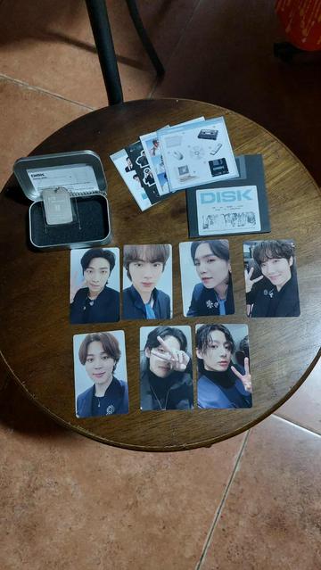Inside the BTS 7 Moments box are 7 photo cards, 4 sticker sets, a QR code on a metal keyring.