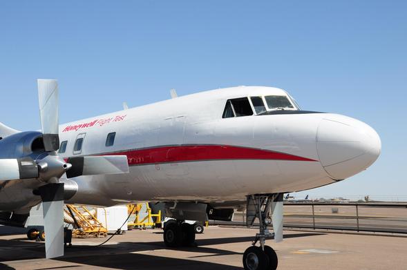 super classic twin engined prop plane with white paint and a red stripe