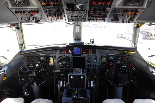 View of the super classic flight deck, with a few modern enhancements. Lots of manual switches and knobs.