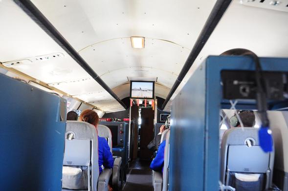 A view from the inside of the classic plane, each seat has screens and are plugs to hear audio from the flight deck and various systems.