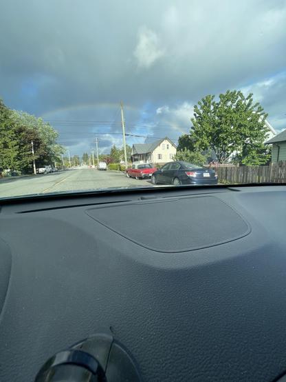 rainbow in the distance out the windshield