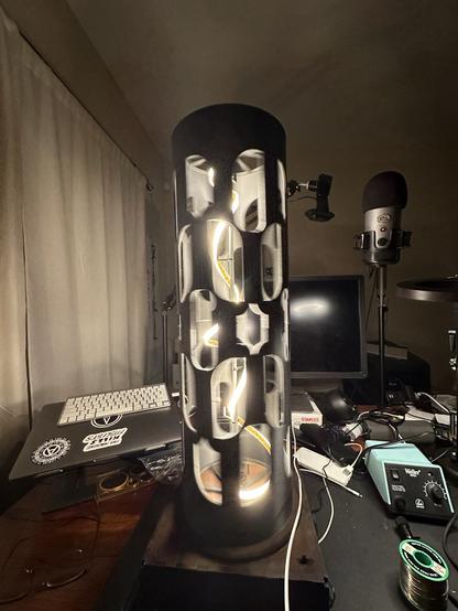 Dreammachine.

It’s a table lamp that looks like a vertical helix of light. Around this light is a rotating black cylindrical shade with holes cut it on it. As the shade rotates, the light appears to flicker. Get the frequency right and stare into the light with your eyes closed and you’ll start to hallucinate and/or enter a trance