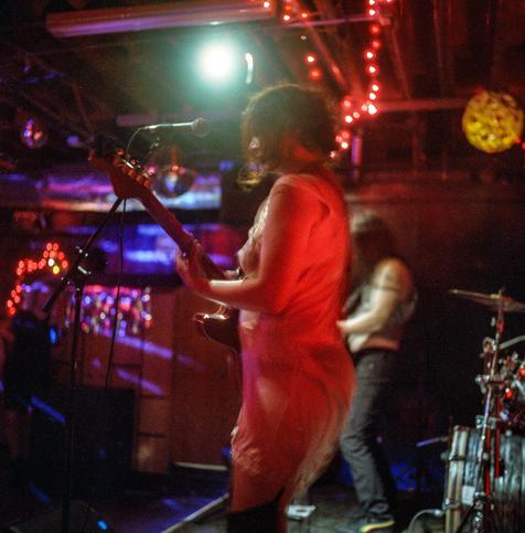 band on stage in basement venue, view from stage left