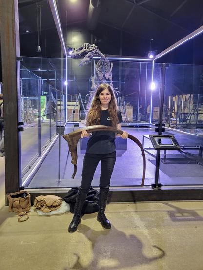 Photo of myself holding a dorsal rib of "Trinity" (TRX-293) at the Museum of Evolution at the Knuthenborg Safari Park. In the background is the display area where it will be mounted and the resident Allosaurus "Big Joe".