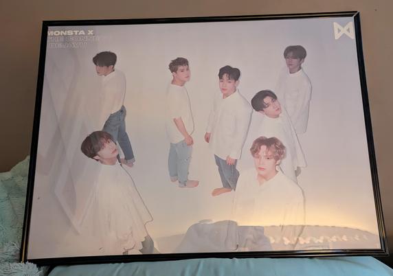 Image shows a framed poster of ot7 Monsta X.