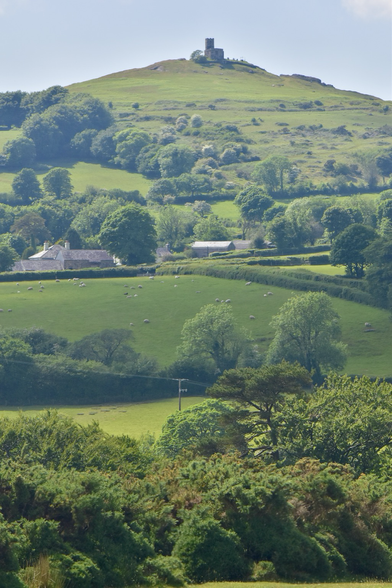 A medieval church on top of layers of fields.