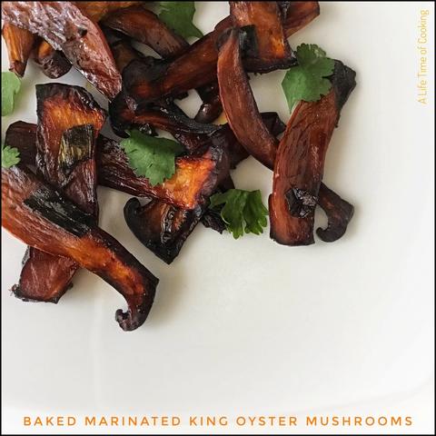 King oyster mushrooms sliced vertically, marinated and baked, on a white plate with parsley.