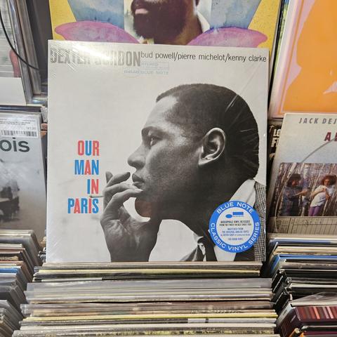 Album cover features a black and white photograph of DG in profile. He's holding a cigarette next to his chin, and squinting slightly.  The title is in alternating red and blue letters, emphasizing the French origin of the recording.
