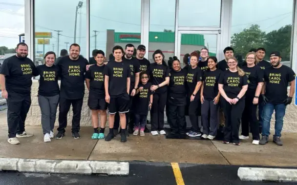 John’s Waffle & Pancake House staff and Carol Mayorga’s children, center, pose for a portrait earlier this week after raising more than $20,000 for the woman’s legal defense fund. They are wearing "Bring Carol Home" shirts.