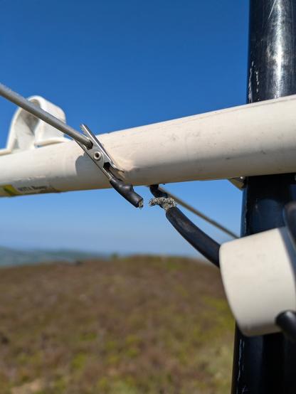 A coax cable with crocodile clips is attached to a driven element of a 3 element 2m yagi (SOTABEAM). The braid has almost totally disconnected from the crocodile clip, only holding on by two strands.