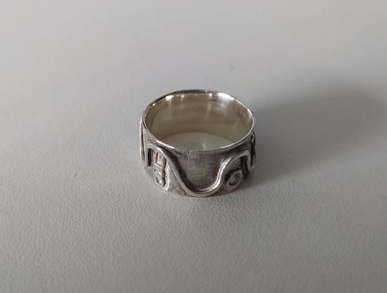 another side of the silver ring with abstract motifs