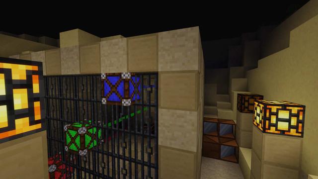 A sandstone house in a sand pit with 3 colorful lasers pointing inside.