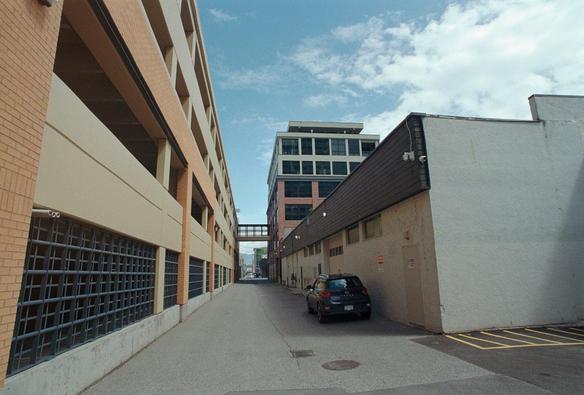 A wide angle shot of an alley in Kelowna. One lone car is parked there. 

Kodak Ultramax 
AF Nikkor 20mm f2.8 D
Nikon F-601