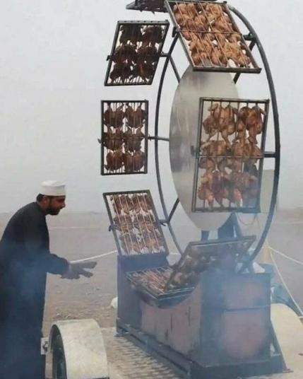 Man barbecues on giant spinning barbecue