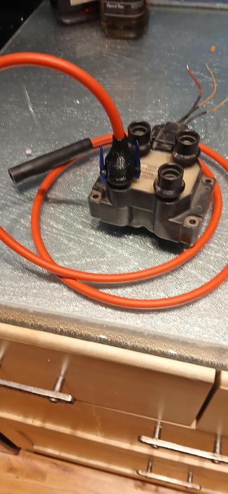 Black Ford EDIS module with red spark plug wire