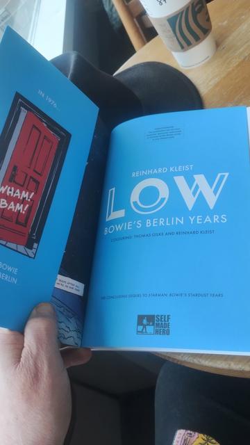 Holding a copy of Low open to show the French Flaps