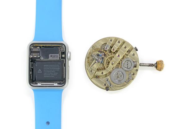 Original Apple Watch on the left with its screen removed, revealing its internals (battery, Taptic Engine, etc.). On the right is the internal mechanism (gears) of a traditional mechanical watch, complete with the exterior knob.