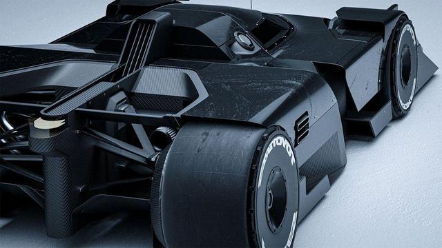 A sleek black racing car with a carbon fiber texture, showcasing its rear design, large tires, and detailed aerodynamic features.