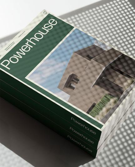 A stack of "Powerhouse" brochures featuring modern architecture on the cover, illuminated with a patterned shadow overlay.