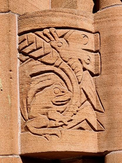 A relief sculpture featuring a frog and a butterfly.