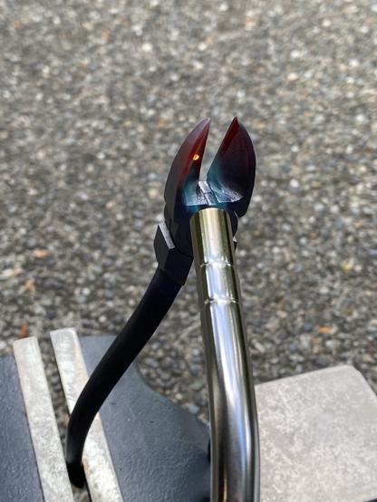 a slightly different angle makes it look like the bright red spot on the otherwise at best dimly red wire snips being hardened sticks out from the surface