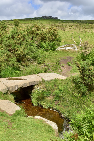 A tor on the horizon with a bridge in the background.