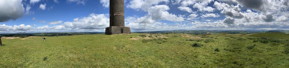 The view from the memorial, a panorama with the English Brder to the right against a blue sky with the od cloud littering the sky