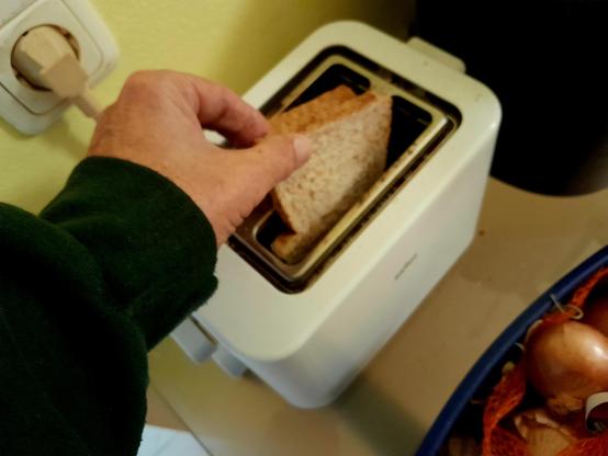 Yours truly putting the toast in the toaster, round side down.