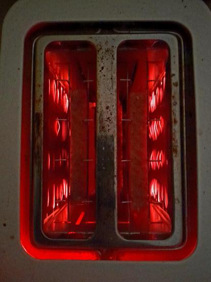 Toast toasting in the toaster, round side down. 
Glowing filaments in the toaster remind me of the scene in 2001 where Dave lobotomizes HAL.